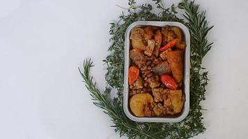 Stir-fried spicy krecek, Indonesian specialties served simply in an aluminum place and a few leaves make the background beautiful photo