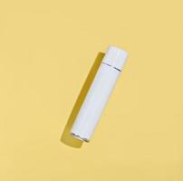 white aerosol spray bottle on a yellow background. mock up. photo