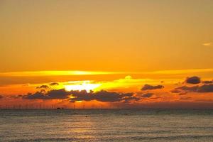 Sunset by the sea in colorful play of light in the clouds. Blavand Denmark. photo