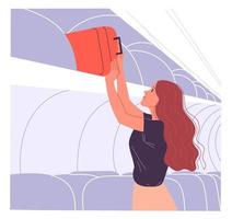Woman passenger puts her hand baggage on the overhead shelf vector