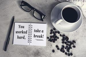Inspirational quote on notepad with coffee and coffee been background. photo