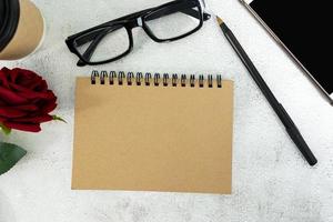 Brown note book on marble desk. Directly above. Flat lay. Copy space. photo