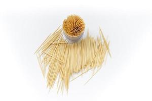 Pile of round wooden toothpicks on white background. Copy space. photo