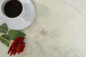 Coffee with red rose on marble desk. Top view. Flat lay. Copy space.