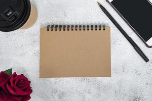 Brown note book on marble desk. Directly above. Flat lay. Copy space. photo