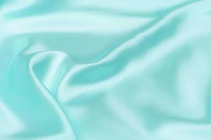 Cyan-Teal satin fabric texture soft blur background photo