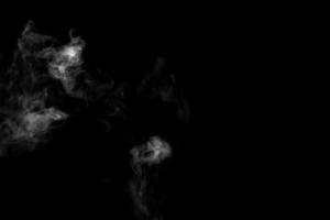 Abstract powder or smoke effect isolated on black background photo