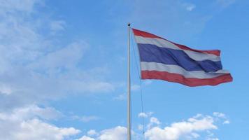 Thailand flag pole moving in strong wind over bright blue cloud sky video