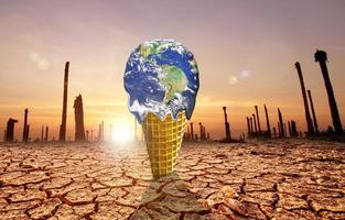 The concept of global warming and environmental change. Melting world on ice cream cone photo