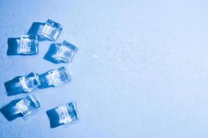 Ice cubes on studio blue background. The concept of freshness with coolness from ice cubes. photo