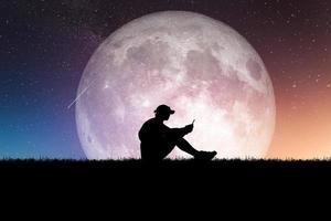 Concept of loneliness and disappointment in love. Sad man sitting element of the picture is decorated by NASA photo