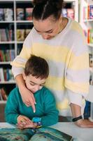 Mom gives her son his first watch. Learning to determine the time by the clock. photo