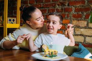 Mom and son are having fun and celebrating children's birthday. photo