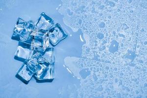 Ice cubes on studio blue background. The concept of freshness with coolness from ice cubes. photo