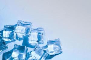 Ice cubes on studio blue background. The concept of freshness with coolness from ice cubes. photo