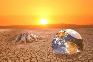 The concept of global warming and drought and poverty and food shortages. Arid soils with hot climates have a globe that lacks green space. photo