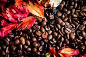 The background image is made of coffee beans decorated with flowers. background concept for coffee shop photo