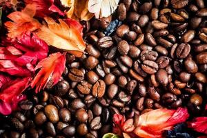 The background image is made of coffee beans decorated with flowers. background concept for coffee shop photo