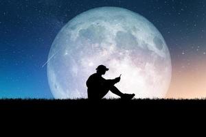 Concept of loneliness and disappointment in love. Sad man sitting element of the picture is decorated by NASA photo