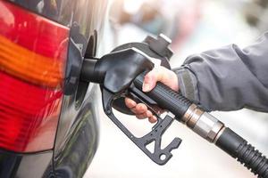 Gasoline pump during supply to a car photo