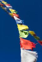 Closeup of colorful Tibetan Buddhist prayer flags waving in the photo