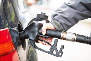 Car during a refueling at the diesel distributor photo