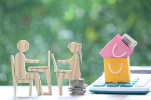 Online income,Man and woman using laptop computer and paper shopping bag with calculator on natural green background, Shopping and Increase taxes concept photo