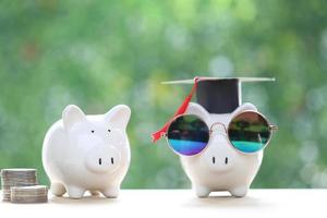 Graduation hat on piggy bank with on nature green background, Saving money for education concept photo
