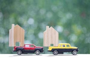 Model house on Miniature car model on nature green background, Investment and business concept photo