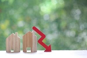 Finance, Model house with red arrow graph on natural green background,Business investment and Save money for prepare in future concept,Inflation photo