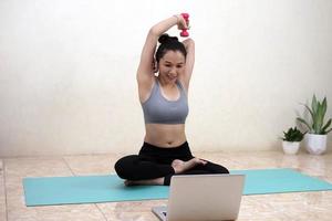A woman doing yoga exercise at home photo
