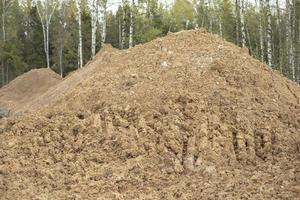 Sand on construction site. Building material is piled up in heap. photo