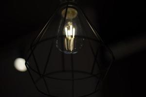 Lamp in dark. Lamp in night. Incandescent lamp. photo