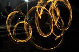 Circles of fire. Lines of flame. Shooting fire show on long shutter speed. photo