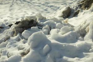 Snow removed from road. Pile of snow outside. Dirty roadside. photo