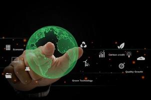 Green Globe hand carbon emissions and environmental protection, the future uses the technology of resources to reduce pollution.ESG business concept. photo