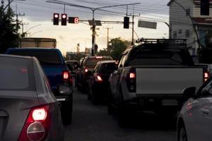 Abstract and blurred of rear side  cars stop on the asphalt road by traffice control red color in Thailand. Traffic congestion. long queues in the evening. photo