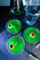 Halloween mad scientist treats of green jello with gummy worms and eyeballs photo