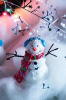 Christmas snowman decorations in festive holiday lights photo