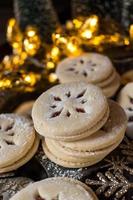 Christmas Linzer cookies with red filling and holiday lights photo