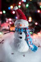 Christmas snowman decorations in festive holiday lights photo