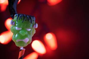 Halloween lollypop in spooky lights setting photo