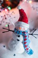 Christmas snowman decorations in festive holiday lights photo