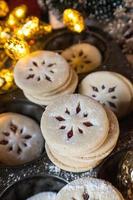 Christmas Linzer cookies with red filling and holiday lights photo