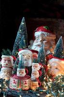 Collection of Christmas Santa mugs in holiday setting photo