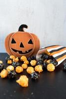 Halloween popcorn spilling out of orange and black bag photo