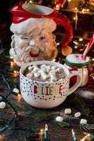 Believe in Santa mug with Christmas decorated setting photo