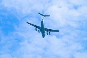 Airplane is flying in blue sky. Commercial passenger and cargo a photo