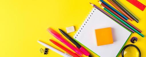Back to school concept. Flat lay of office supplies on yellow background. Place for text. photo