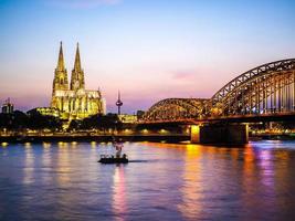 HDR St Peter Cathedral and Hohenzollern Bridge over river Rhine photo